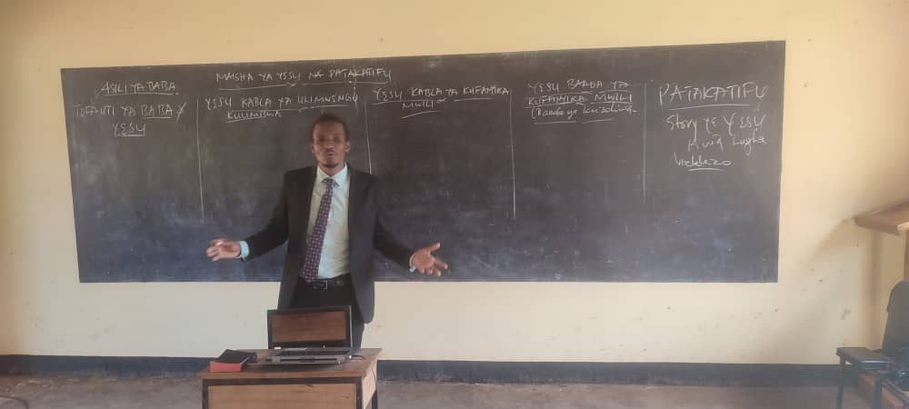 A teacher explaining the life of Christ and the sanctuary at the blackboard