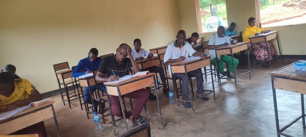 Students at desks writing during a class